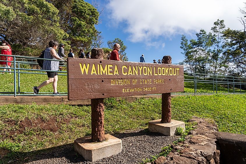 People visiting Waimea Canyon Lookout in Waimea Canyon State Park. Waimea, HI, USA. Editorial credit: JHVEPhoto / Shutterstock.com