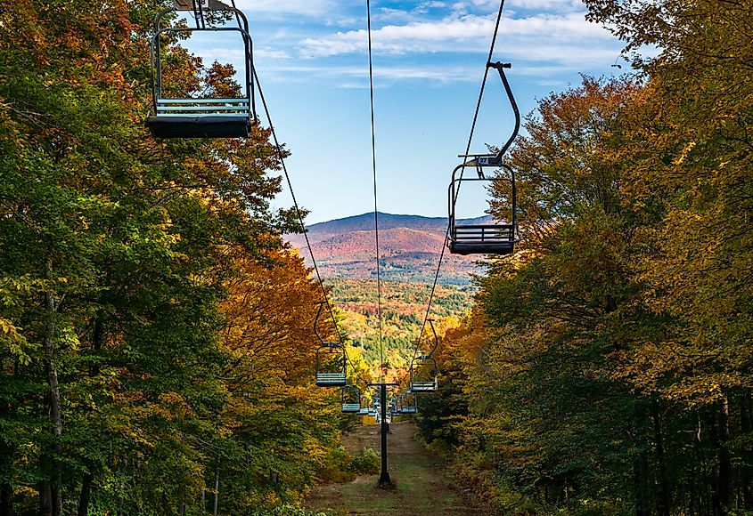 View down Mount Mansfield with ski lift chairs leading down the hillside.