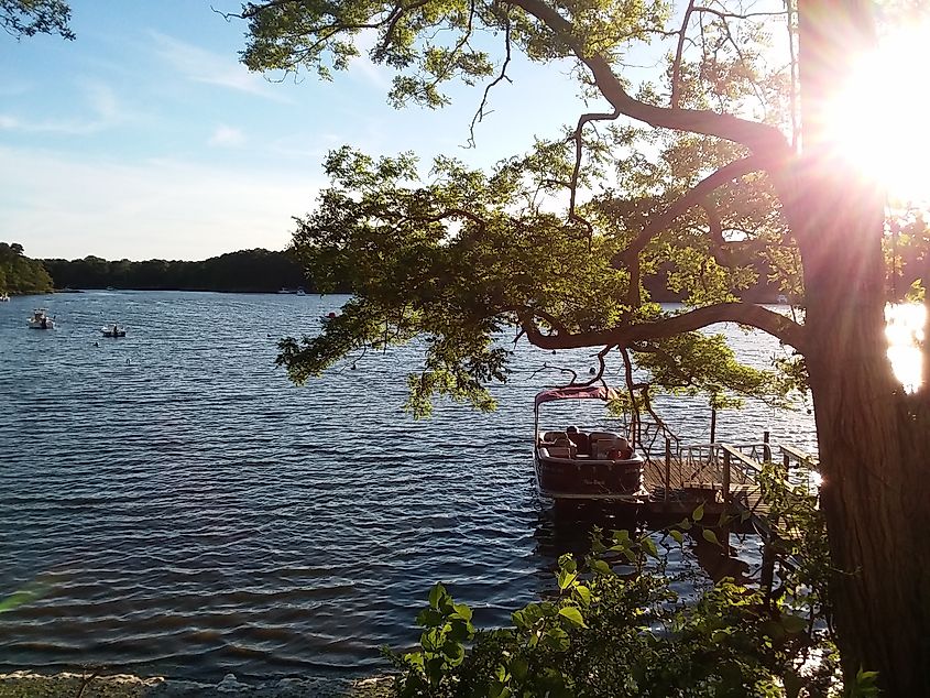 A calm lake surrounded by lush greenery in Mashpee, Massachusetts.