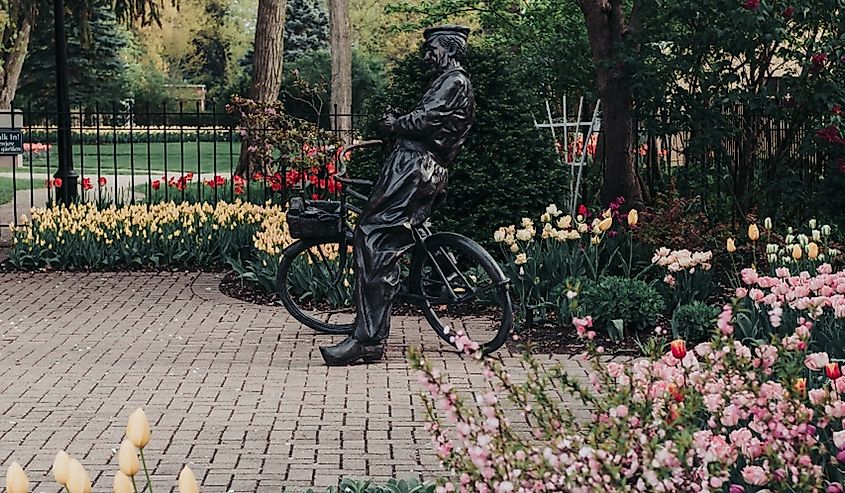 Sculpture of a Dutch man with his bicycle in Scholte Gardens in Pella, Iowa.