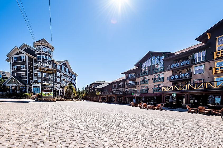 Wide-angle view of the cobbled square in Snowshoe Mountain village, showing a store, restaurant, and Starbucks coffee shop in the small ski resort town of Snowshoe, West Virginia.