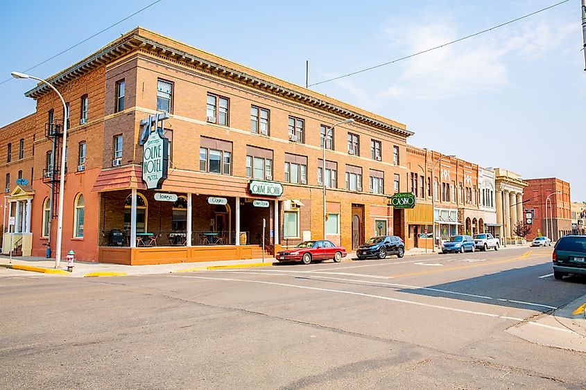 Street view of Miles City, Montana, showing a typical small-town setting with buildings and vehicles along the road.