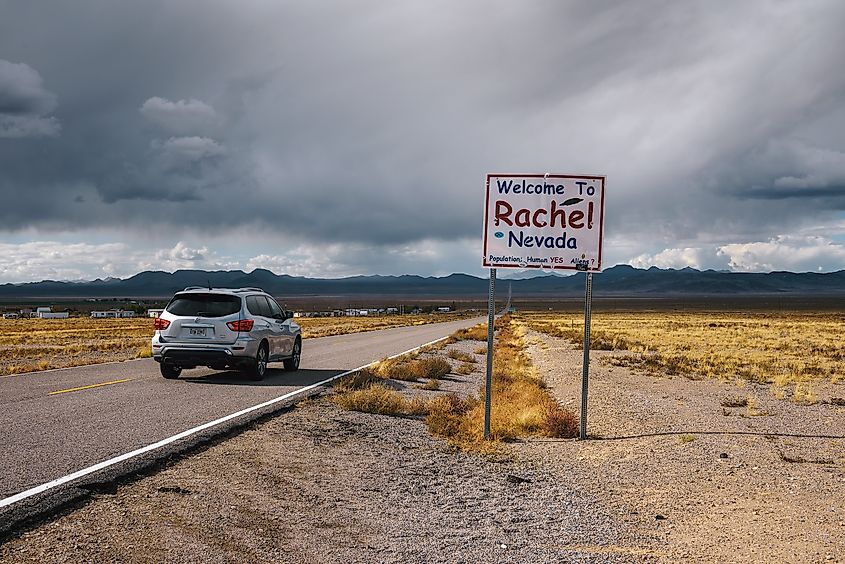 Car passing the Welcome to Rachel street sign on SR-375 in Nevada, also known as the Extraterrestrial Highway.