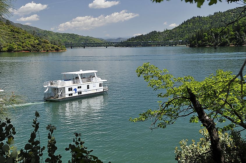 A houseboat navigating the beautiful Shasta Lake in Northern California.