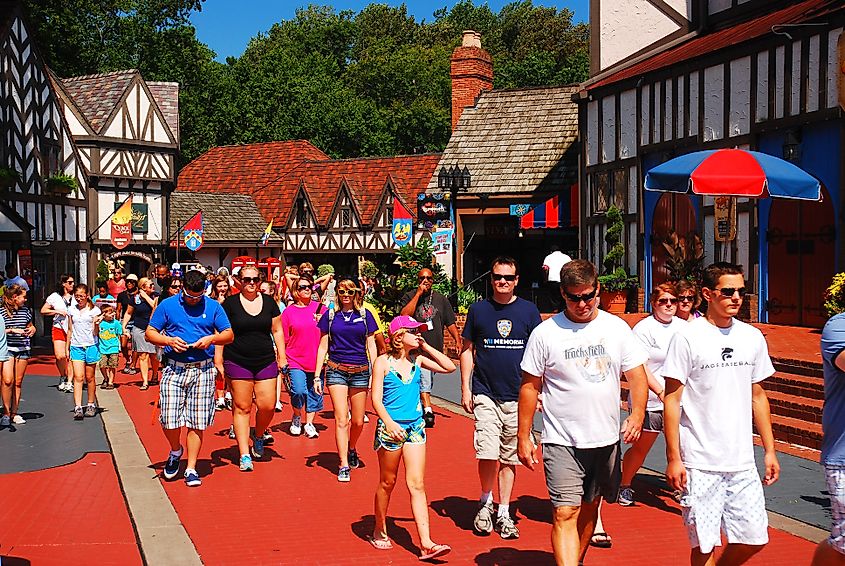 Crowd of people exploring a recreated Tudor Village in Busch Gardens, Williamsburg, Virginia.