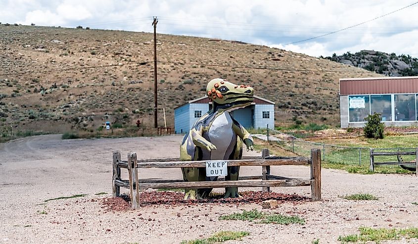 Dinosaur, Colorado with funny dinosaur animal sculpture with keep out sign