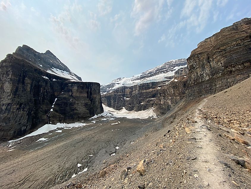 A barren trail leads to glacier-strewn Rocky Mountains