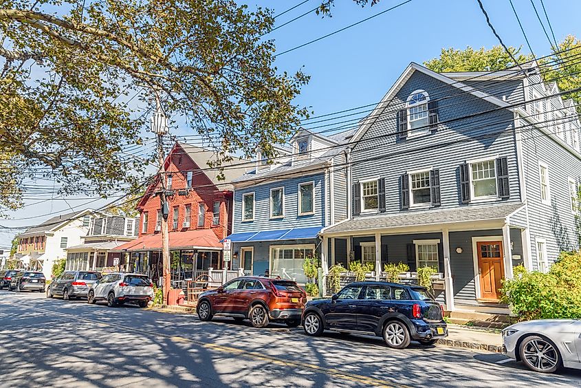 Row of colorful wooden residential and commercial buildings along a street in the historic town center of Piermont, New York.