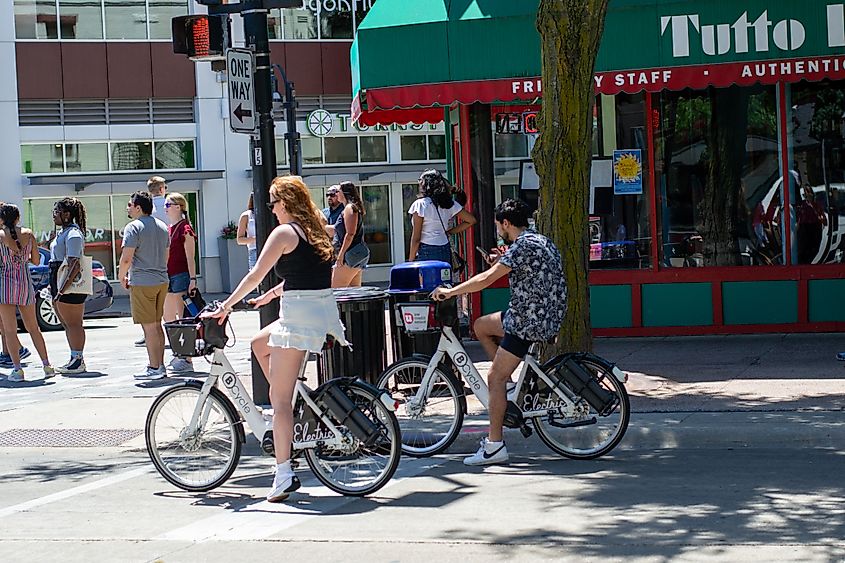 People riding electric bicycles on the streets of Madison, Wisconsin