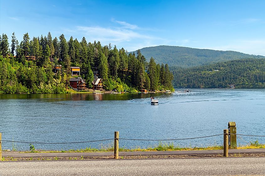 A motorboat with an American flag on the water at Lake Coeur d'Alene's Bennett Bay