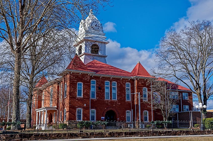 Restored historic building with a clock tower with a bell hanging inside the cupola in downtown Wartburg in the Tennessee.