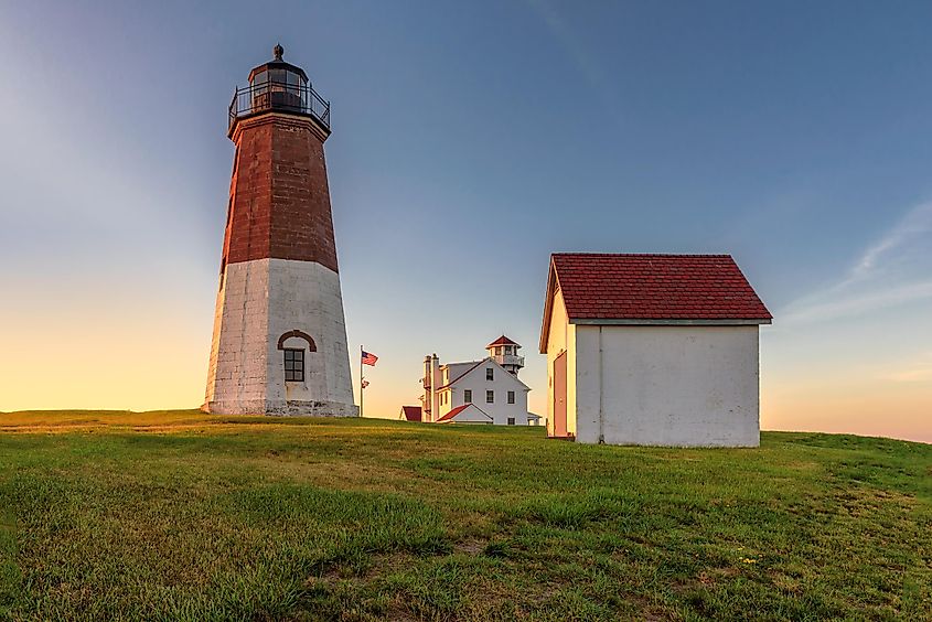 The Point Judith light near Narragansett, Rhode Island, against a bright sunset.