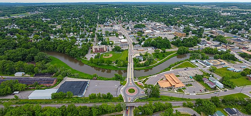 Aerial view of downtown Baraboo, Wisconsin, showcasing the town's historic buildings, streets, and surrounding landscapes, with a scenic blend of urban and natural elements.