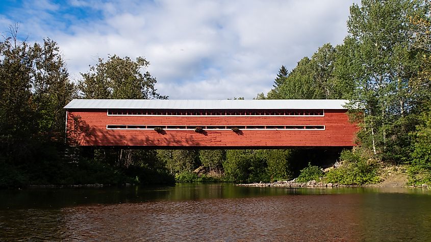 Scenic view of a beautiful covered bridge crossing the Matapedia river, in Amqui, Quebec.