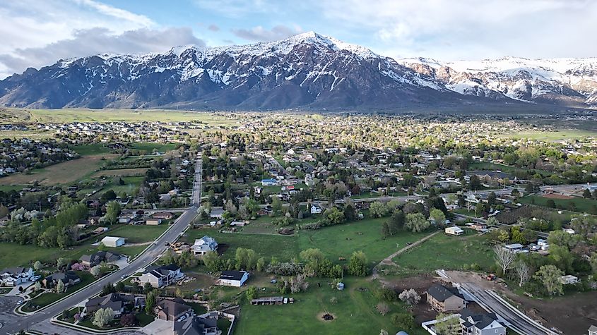 Pleasant View Utah in the spring, with a view of Mount Ben Lomond. Image Credit shanewazhere via Shutterstock.