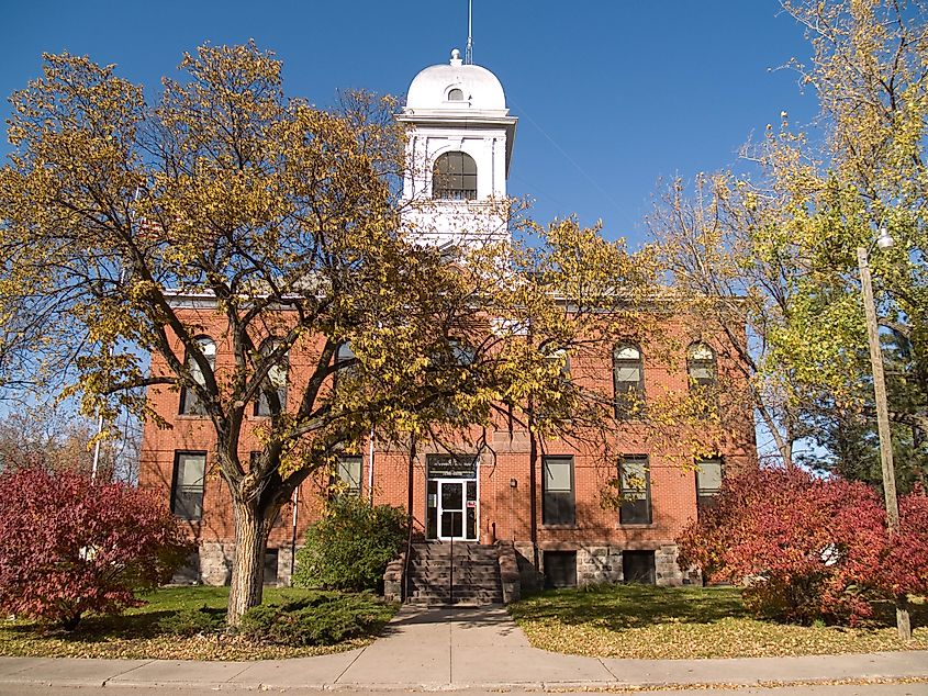 The Eddy County Courthouse in New Rockford, North Dakota, a stately brick building with a prominent entrance and well-maintained grounds.