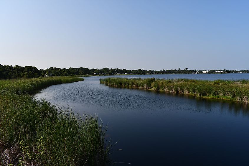 Gulf Shores State Park in Alabama is known for its beautiful white sand beaches, scenic hiking trails, and diverse wildlife