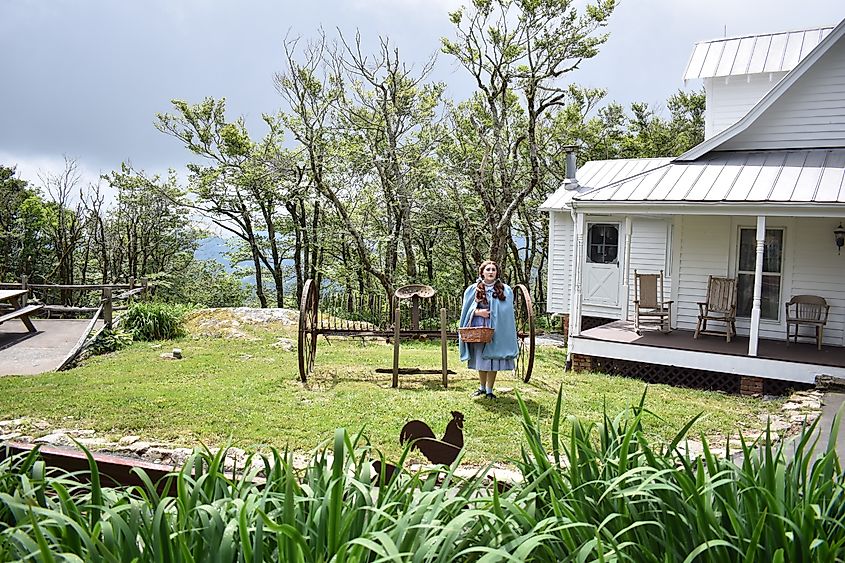 Land of Oz, Dorothy Standing in front of the Gale's family Farm House in Beech Mountain, North Carolina. Editorial credit: Janell Queen / Shutterstock.com