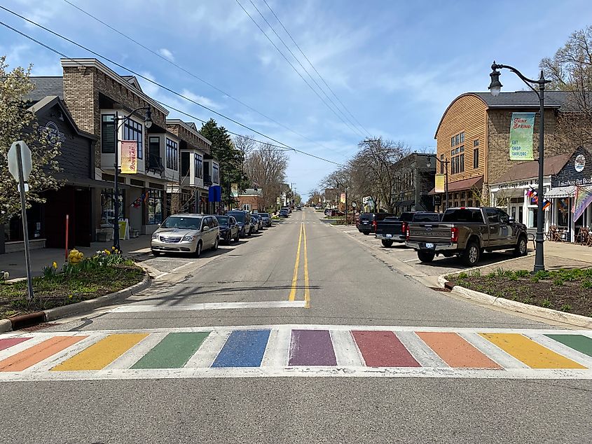 A rainbow crosswalk cuts across a small town's main street.