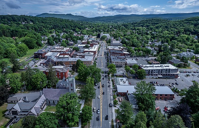 Aerial view of Great Barrington, Massachusetts, in summer, showcasing the town's lush greenery and charming buildings nestled in the scenic landscape.