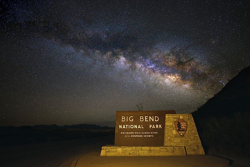 A sign for the Big Bend National Park sign stands under a clear, star-filled sky with the Milky Way prominently visible. Editorial credit: kbrandau / Shutterstock.com