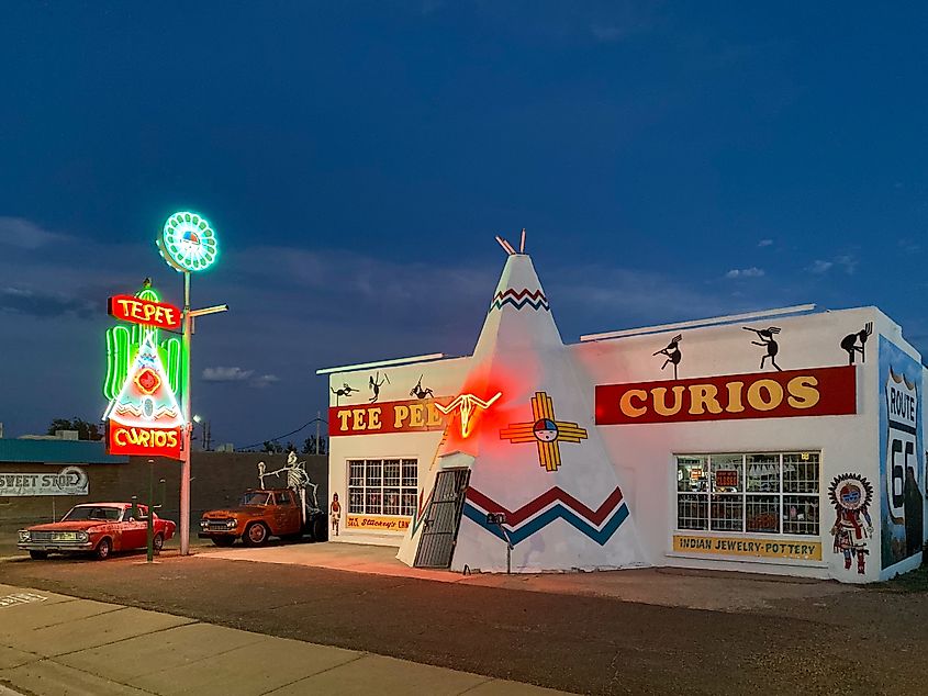 Neon sign of Tee Pee Curios at night in Tucumcari. Editorial credit: SveKo / Shutterstock.com