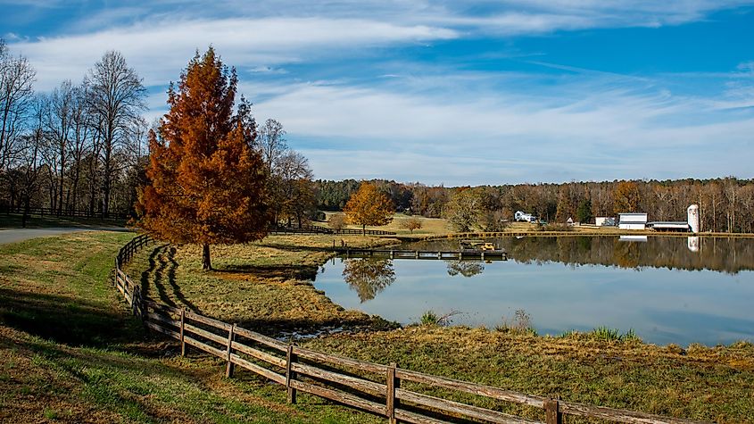 North Carolina: Reflection of farm buildings on a lake.