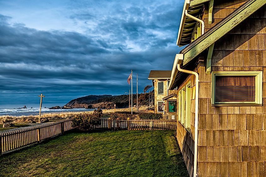 Winter sunset casting a golden light over beach houses in Cannon Beach, Oregon, USA.