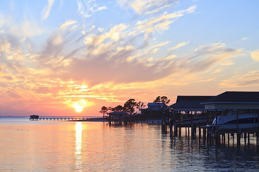 Colorful sunset and boats sheds off the coast of Gulf Breeze, Florida