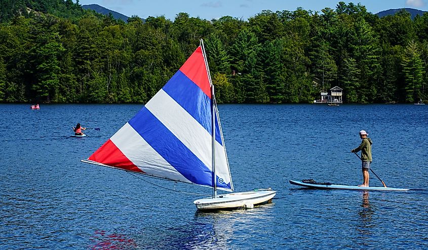 Water boarder enjoys summer day on Mirror Lake in Lake Placid, New York State