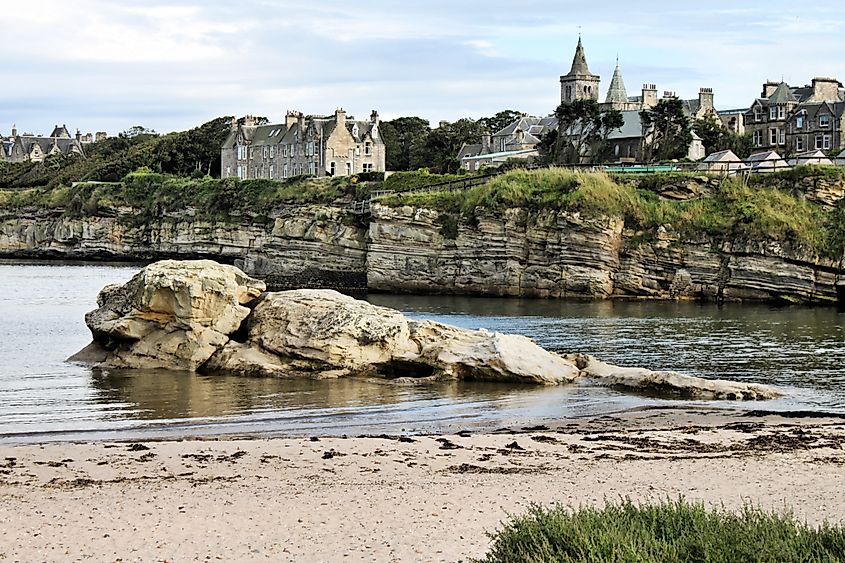 A view of St Andrews, Scotland, featuring the historic town with its iconic university buildings, medieval ruins, and the expansive coastline along the North Sea.