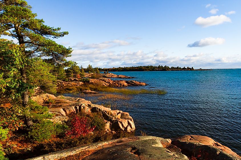 Shoreline along lake Huron. Granite Red rocks at the mouth of the Chikanishing Creek. Georgian Bay. Killarney Provincial Park, Ontario, Canada