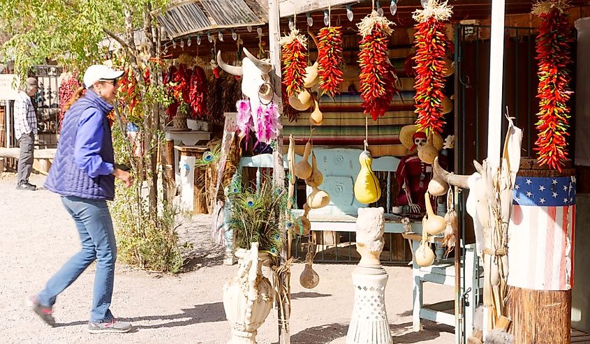 Tourist looking at the ristras hanging in front of the store in Mesilla, New Mexico. Image credit Grossinger via Shutterstock