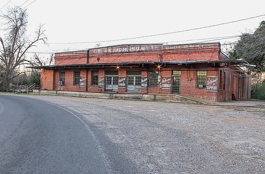 A historic warehouse with a gravel lot in the evening light in Natchitoches. Editorial credit: Sabrina Janelle Gordon / Shutterstock.com