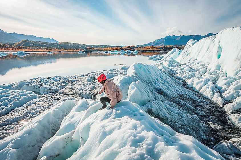 Woman hiking on Matanuska Glacier near Glenn Highway in Alaska.