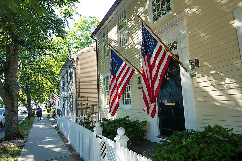 American flags and a white picket fence line Main Street in Essex, an all-American village. Editorial credit: Jeff Holcombe / Shutterstock.com