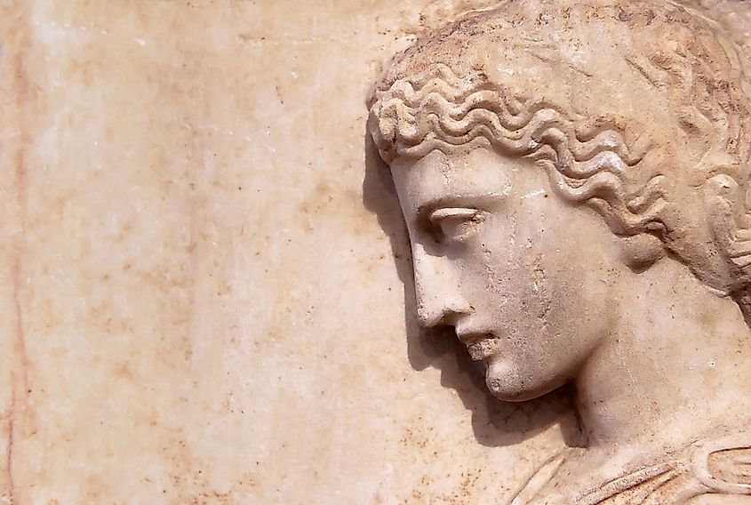 Ancient Greek relief of woman on marble wall