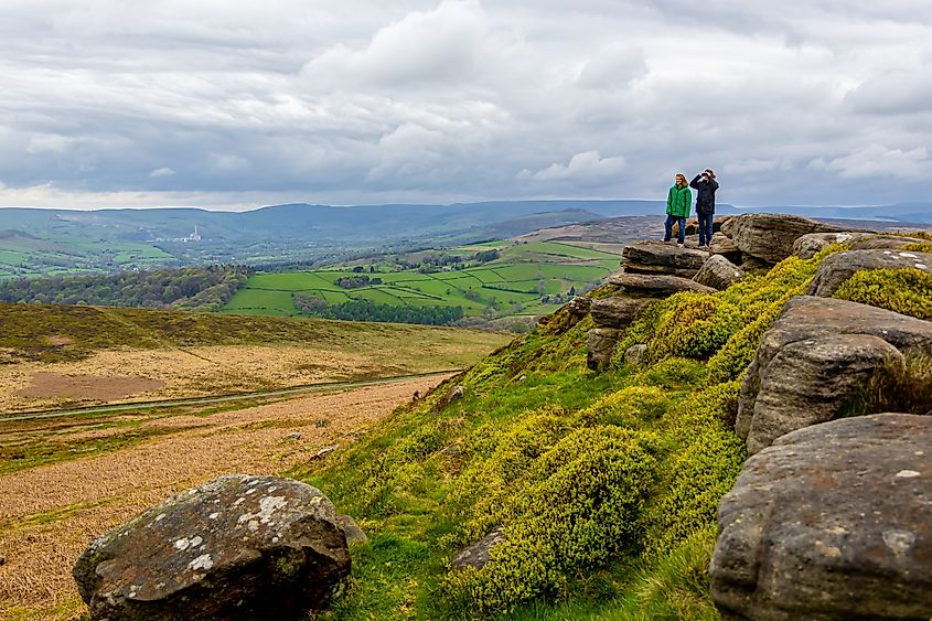 Family enjoying hike in Peak District National Park, UK.