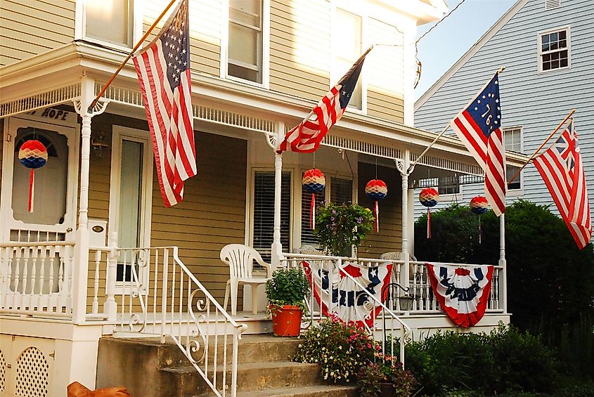 A house in Bristol, Rhode Island flies the stars and stripes on Independence Day. Editorial credit: James Kirkikis / Shutterstock.com