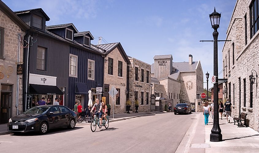 Summertime view along Mill Street West with row of old two-storey houses and Elora Mill building. Editorial credit: Vadim Rodnev / Shutterstock.com