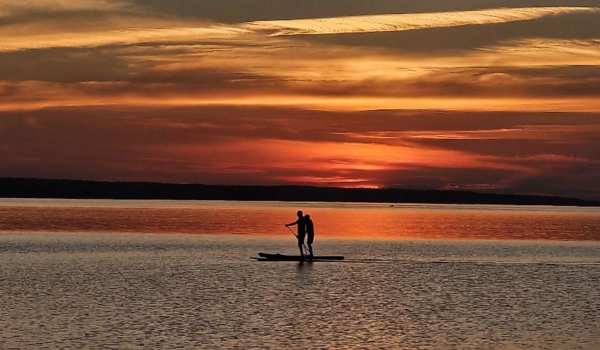 2 people Paddle Boarding on 1 Kayak at Waskesiu Lake near Beaver Glen Campground