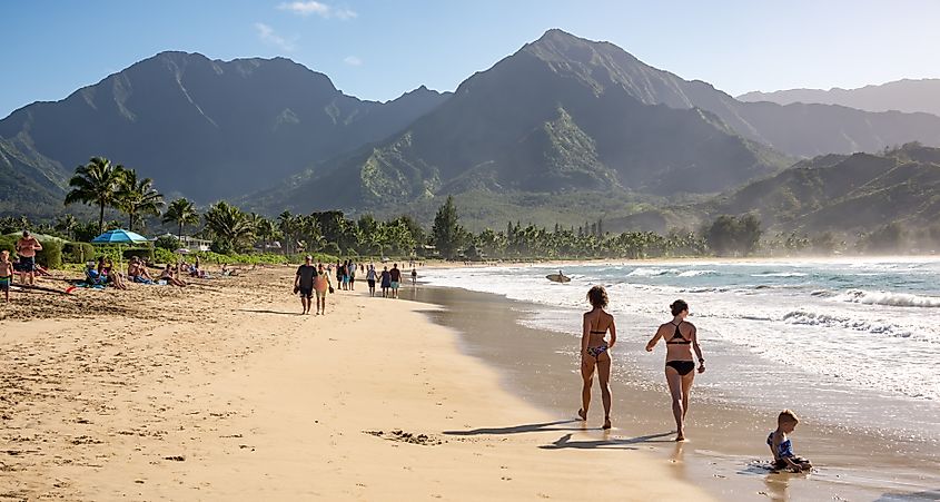 People along Hanalei Bay Beach in Hawaii.