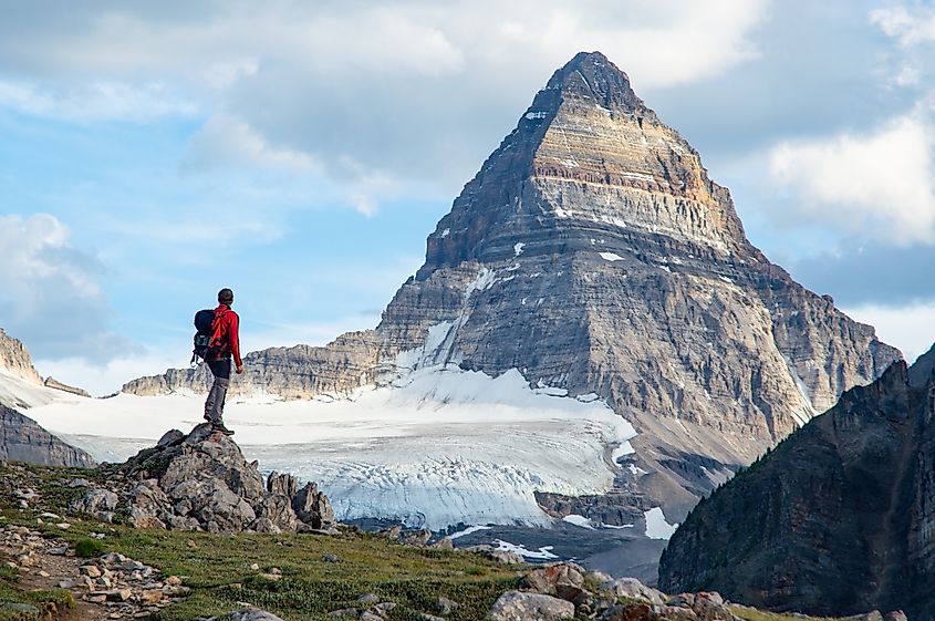 A hiker views Mount Assiniboine