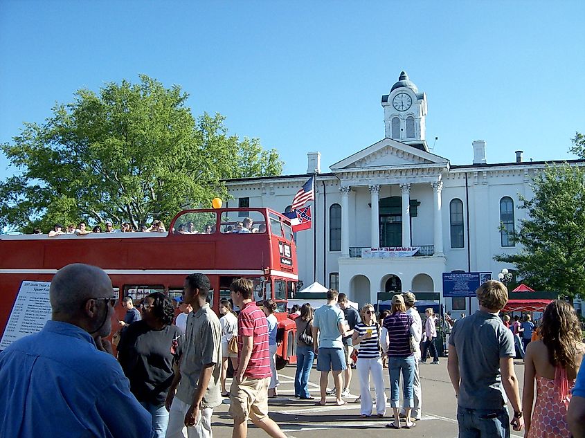 People around a double-decker bus in Oxford, Mississippi.