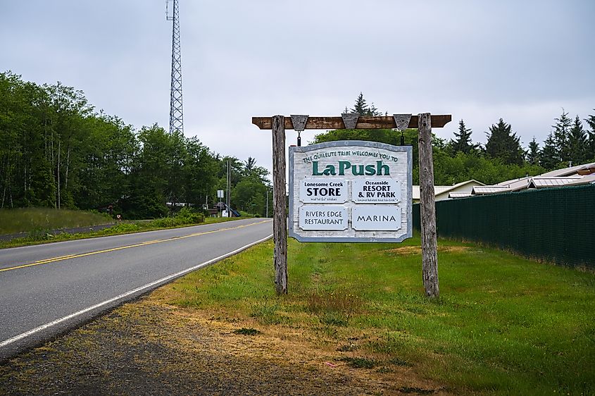 Welcome sign for La Push with directions to local amenities on a cloudy day