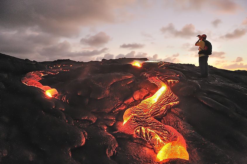 A visitor photographing the Kilauea volcano in the Hawaii Volcanoes National Park.