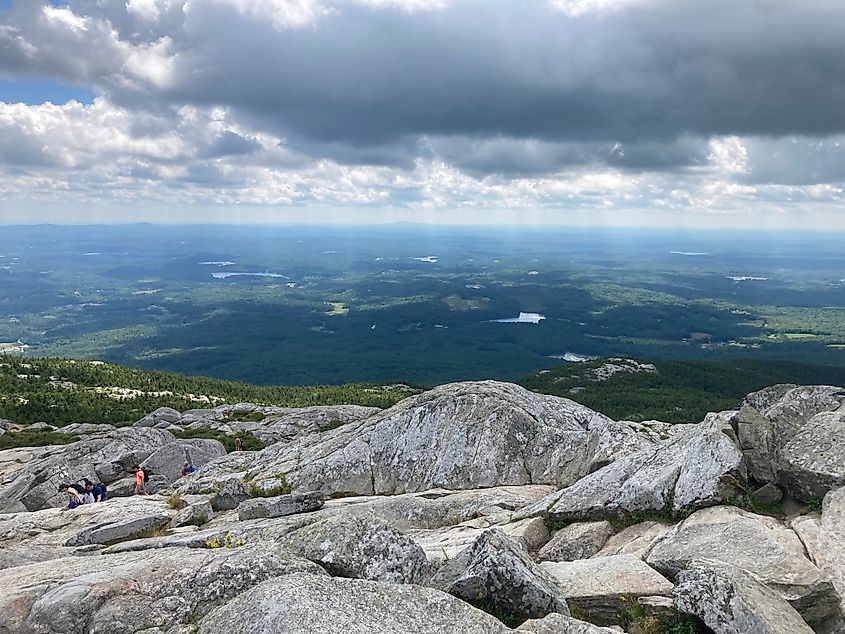 A small group of hikers ascending Mount Monadnock, at Monadnock State Park in New Hampshire. 