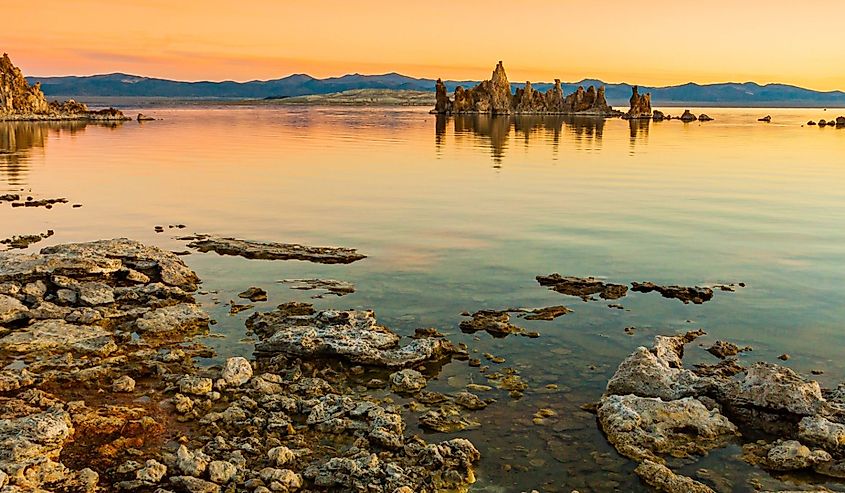 Tufa Towers At Sunrise Reflecting Into The Alkaline Waters of Mono Lake, South Lake Tufa Trail, Mono Lake, Mono Lake Tufa State Natural Reserve, Lee Vining, California.