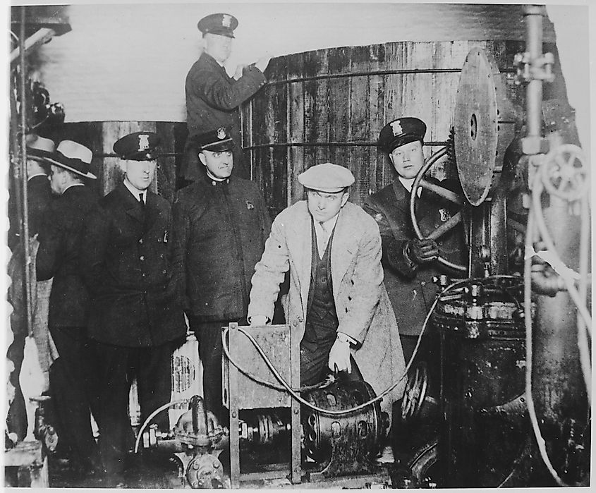 Michigan and Detroit policemen inspect the equipment used in a clandestine brewery in a bust.