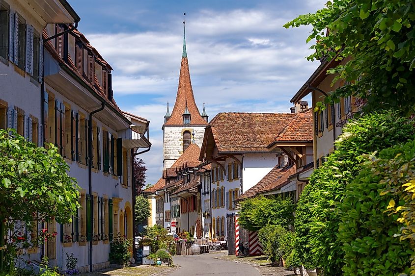 Road with church in the background at the medieval old town of Murten, Switzerland.